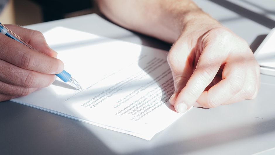 Signing document desk pen - Funeral Claim Declined: What You Can Do