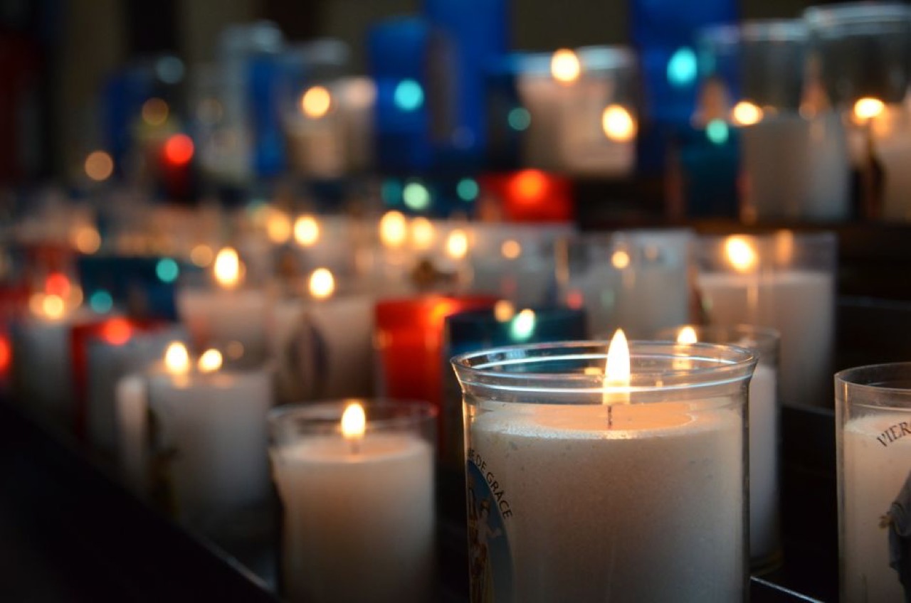Funeral parlour vs funeral cover: what's the difference? Candles glowing warm - Funeral parlour vs funeral cover: what's the difference?